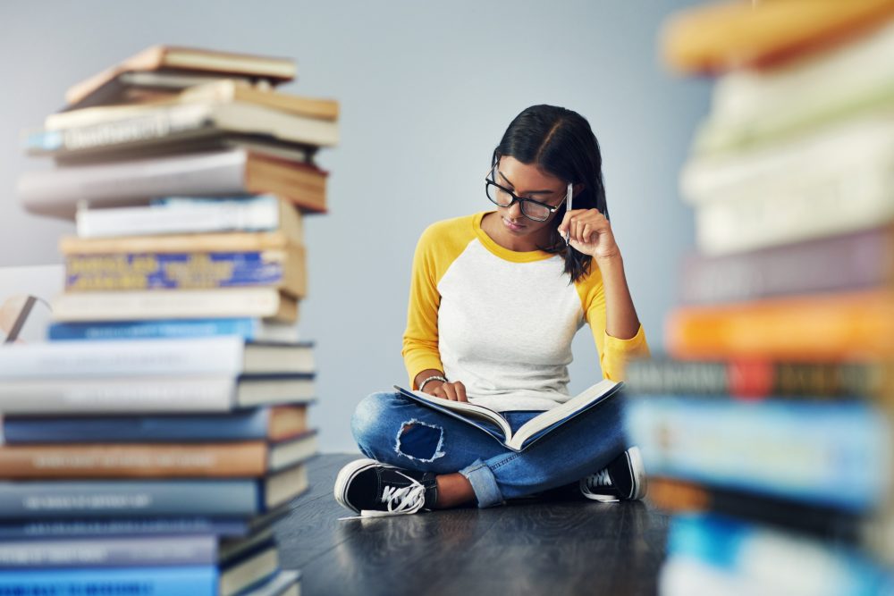 Girl studying with a book on her lap