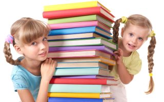 Children reading pile of book. Isolated.