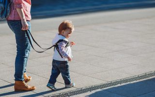 Mothers teach to walk on the road