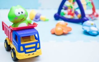 Children's toys. A small machine close-up for children. playing mat with children's toys.