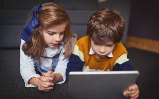 Enjoying activities that can be done anywhere, any time. a little boy and girl using a digital tablet at home