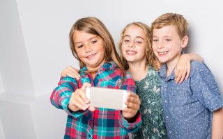 A Group of happy children in studio gray background