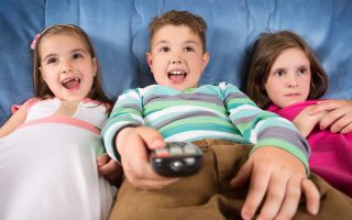 Surprised children watching TV