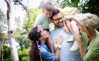 Happy multi generation family enjoying picnic in a park