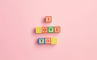 Message I love you spelled in wooden blocks. sign for relationships, romance, love and Valentines day, in letters with heart symbol. Mother's Day, Wedding Day, March 8, father's day