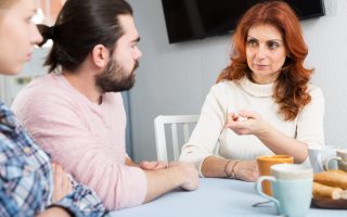 Young married couple and senior mother having bad discussion