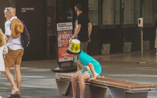 child with a bucket on his head