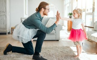 That was great. Full length shot of an adorable little girl giving her father a high five after dancing with him