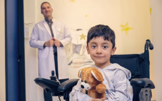Child in hospital wheelchair, undergoing ADHD assessment