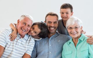 Portrait of happy family sitting on sofa and smiling in living room