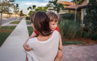 Parent calmly guiding young child