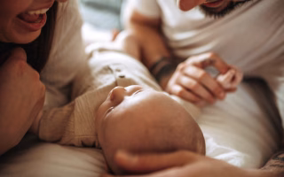A calm parent kneeling beside their child