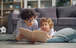 A smiling parent and child sitting together and talking openly, conveying warmth and trust. The image represents emotional intelligence in parenting through connection and communication.