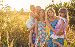 Large group of siblings standing together outdoors