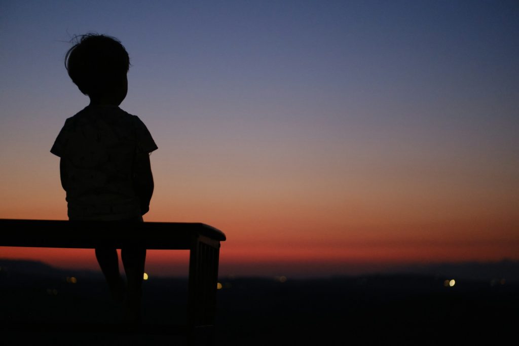 child looking out into the sunset