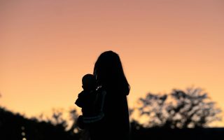 mom with child in the sunset
