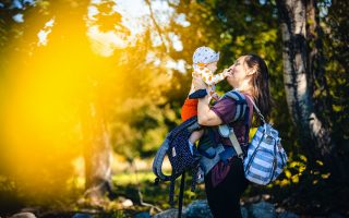 mom holding child in nature