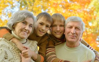 Grandparents and grandchildren together in autumn park