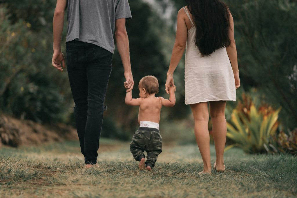 mom and dad walking with baby