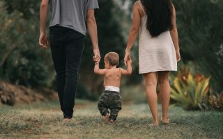 mom and dad walking with baby