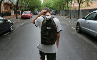 sad teen walking down the street