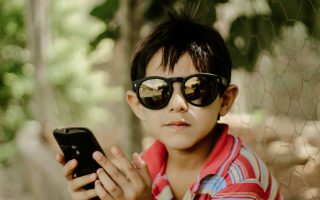 young boy holding a phone