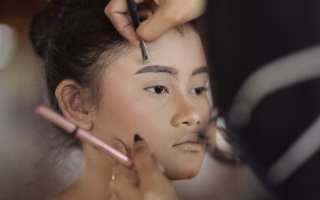 Girl getting makeup done, referencing psychologist-approved age.