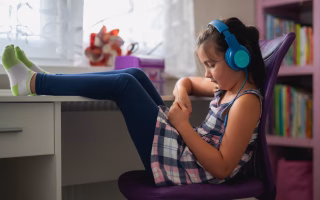 Girl with headphones, showing kids benefit from boredom