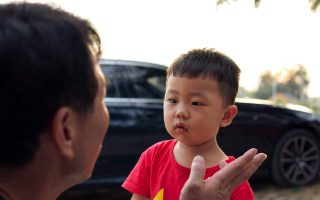 father talking to young son