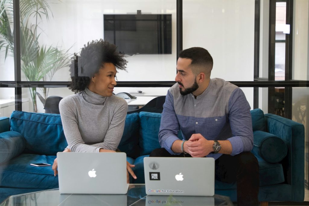 man and woman at work with their laptops