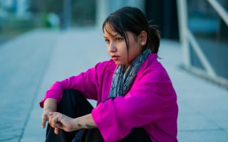 child looking sad while sitting down