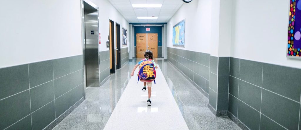 Child In School Hallway