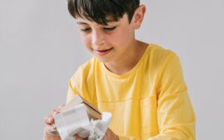 Young Boy Opening Gift