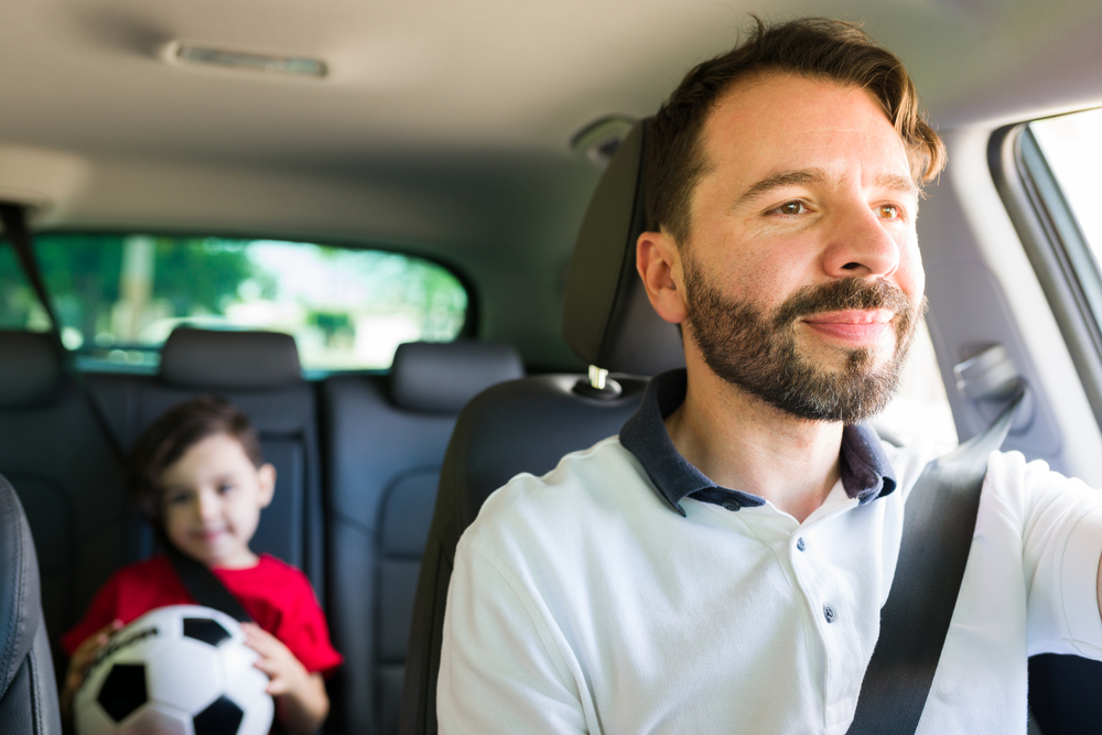 parent driving child sports practice